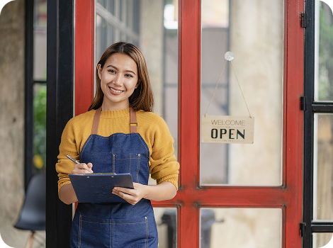 Woman standing at an open storefront